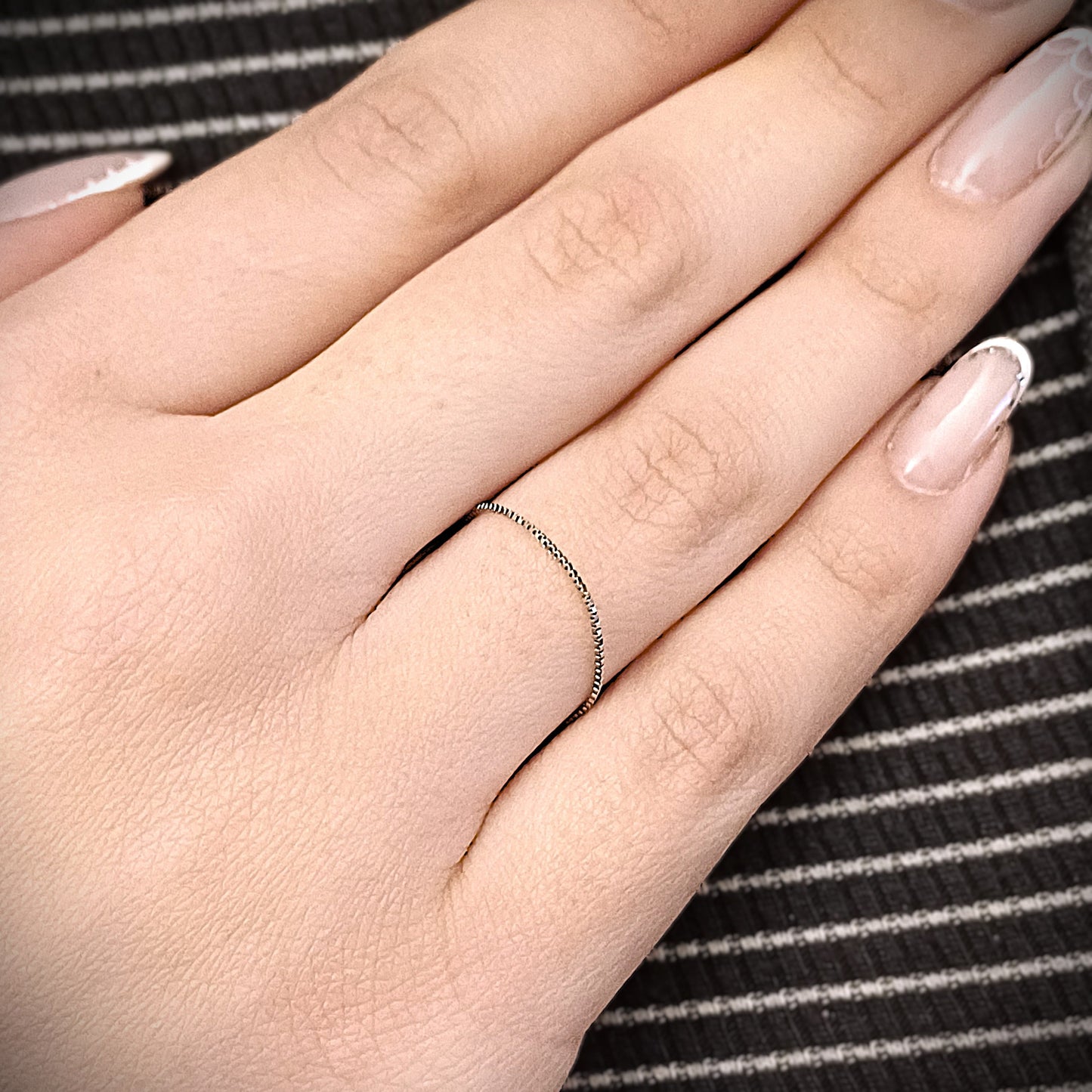 L'Anello UNICO realizzato con la catena Veneziana è un anello d’oro o d’argento saldato direttamente al dito, senza chiusura. Il design è essenziale ed elegante, con una sottile catena scintillante che avvolge delicatamente il dito. Il metallo è liscio, raffinato e leggero, quasi impercettibile al tatto. Disponibile anche con ciondoli personalizzati: un cuore, una lettera, un fiore, il mondo o il numero 18. Un gioiello che diventa parte di te, simbolo di un legame eterno.