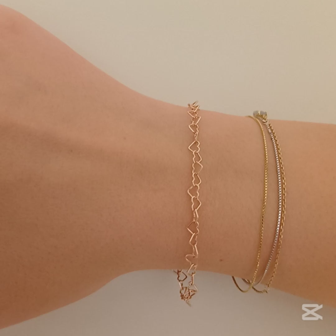 Immagina un bracciale delicato e leggero, composto da una fila di piccoli cuori, questo bracciale è realizzato con un sottile filo d’argento, lucido e liscio al tatto. Il design è semplice ma ricco di significato, ideale per chi ama dettagli raffinati e romantici. Il bracciale, venduto dal nostro laboratorio orafo a Livorno, scivola dolcemente sul polso, regalando una sensazione di leggerezza e una carezza che accompagna ogni movimento.